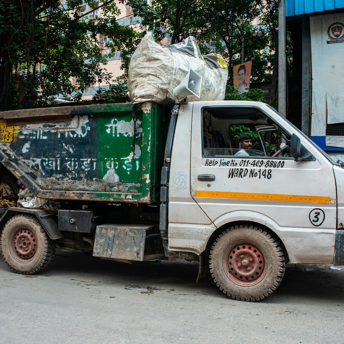 Door-to-door waste collection vehicle on municipal route